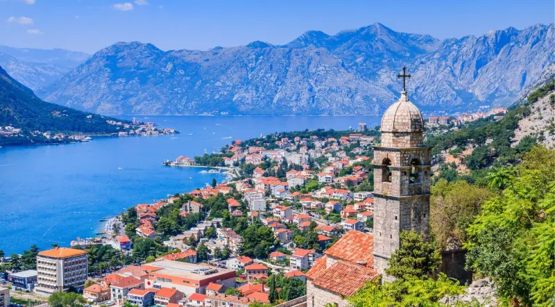 Bay of Kotor with a church bell tower, the old town and mountains behind