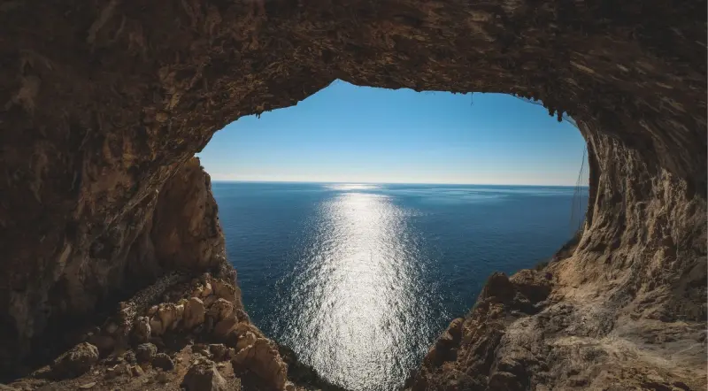 View from inside a sea cave out to the sunlit open Adriatic Sea near Kotor